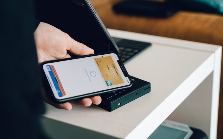 Contactless mobile payment using a smartphone banking app, representing Monzo and Revolut Premium accounts for UK migrants