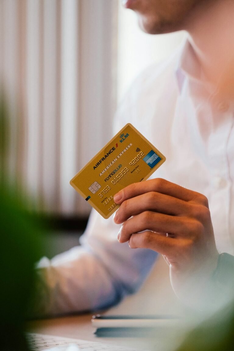 Person holding a credit card, representing a first credit card for someone with no UK credit history