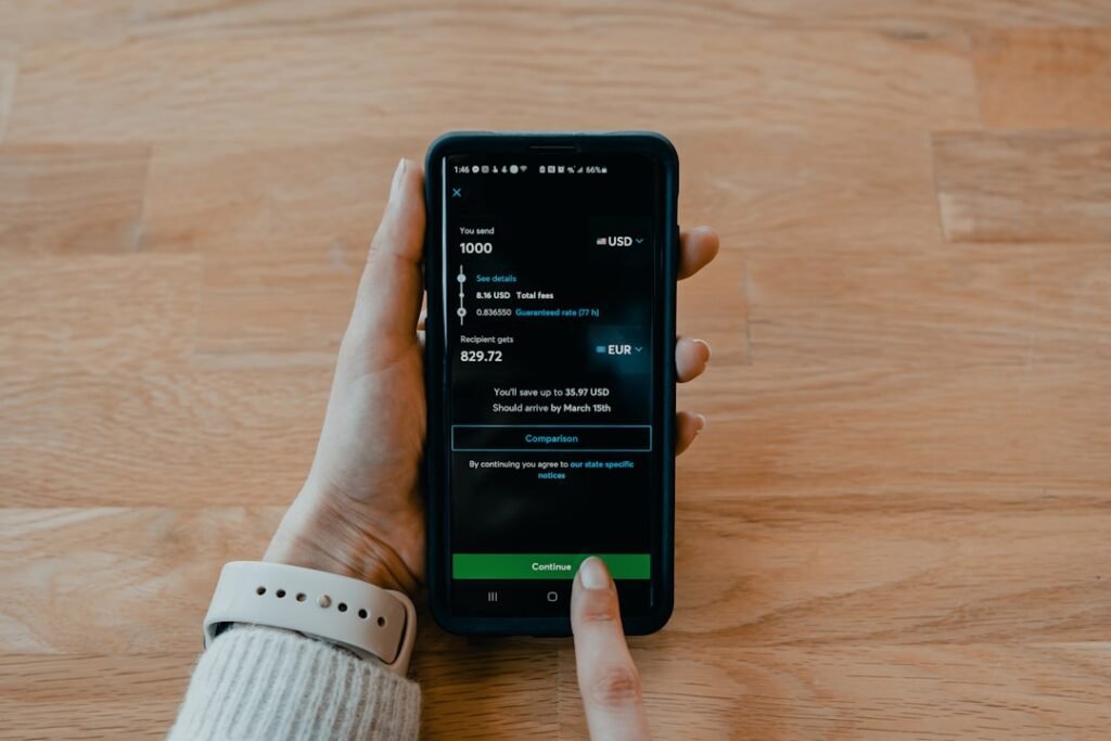 Person using a mobile banking app to send money to a Nigerian bank account from the UK