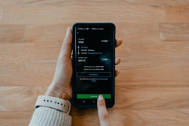 Person using a mobile banking app to send money to a Nigerian bank account from the UK