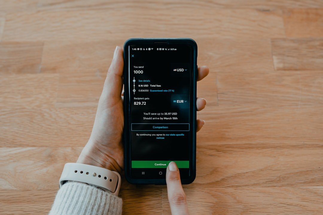 Person using a mobile banking app to send money to a Nigerian bank account from the UK