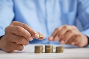 Stacking coins representing UK pension and SIPP savings