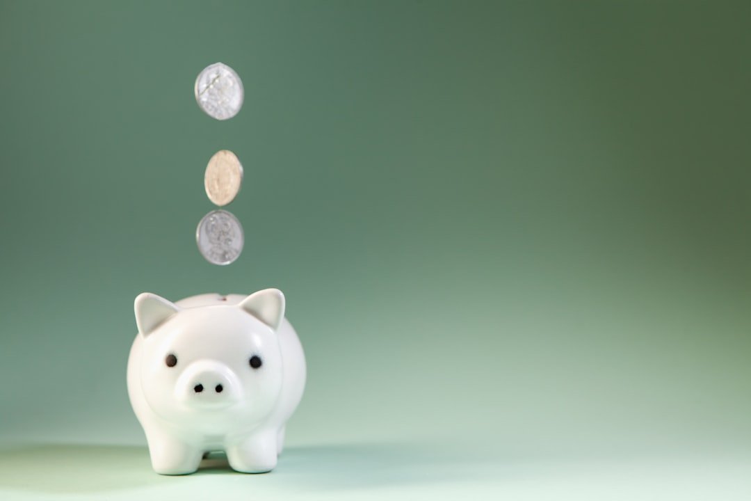 Coins falling into a piggy bank representing a Junior ISA savings for a child