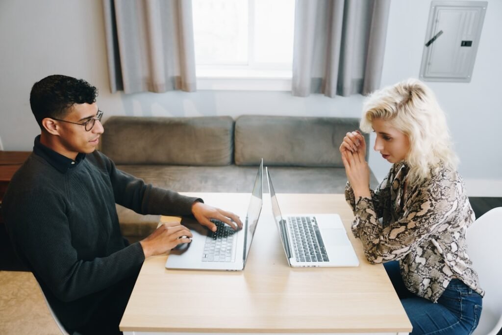 Couple reviewing finances together at a table, representing joint bank accounts for couples with different immigration status