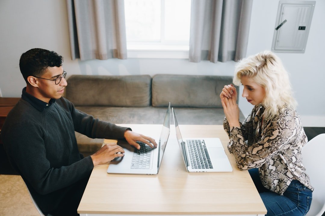 Couple reviewing finances together at a table, representing joint bank accounts for couples with different immigration status